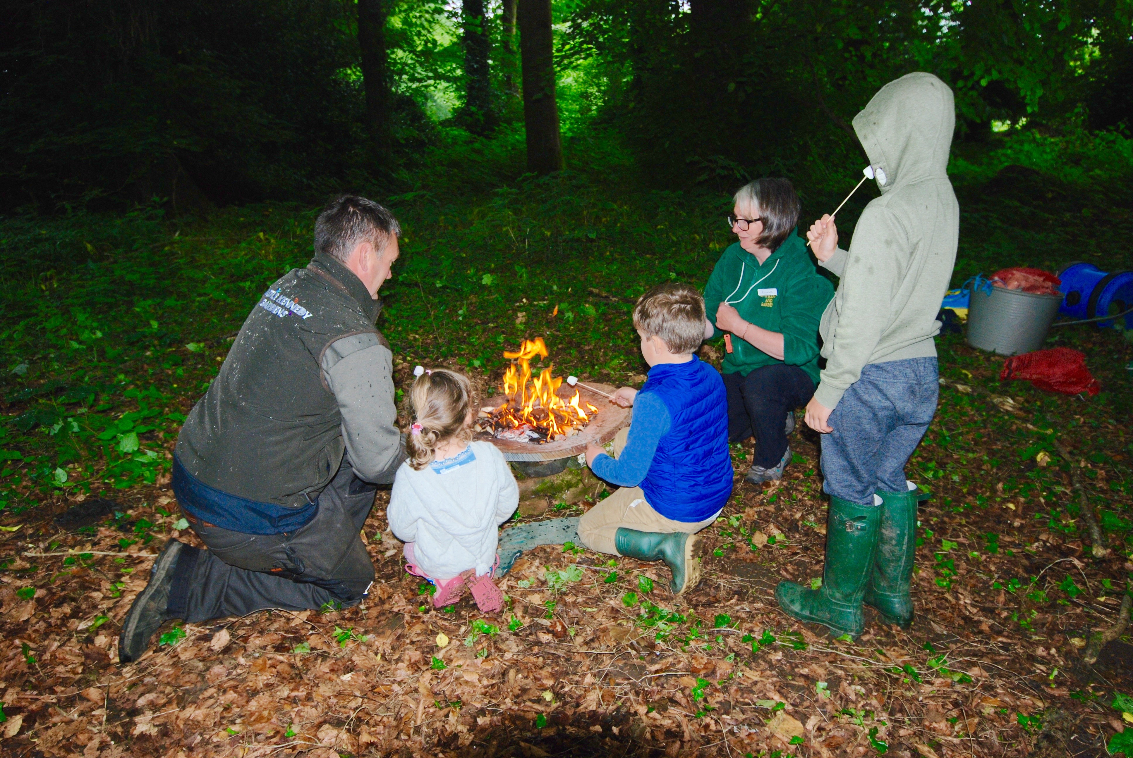 Enjoying marshmallows around the camp fire